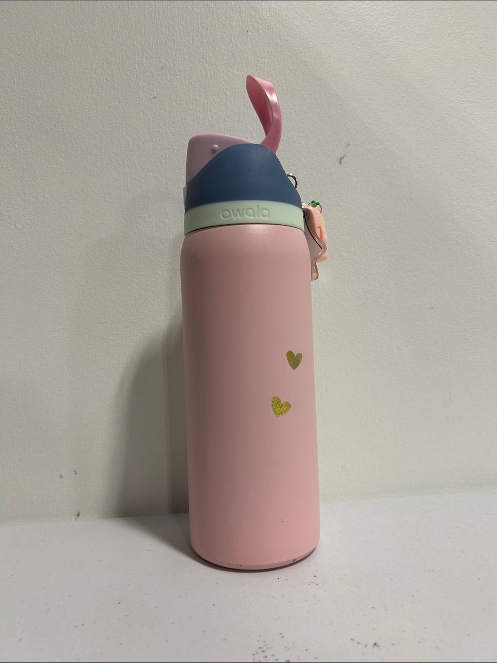 Owala Pink Stainless Water Bottle with Navy Lid and Gold Hearts